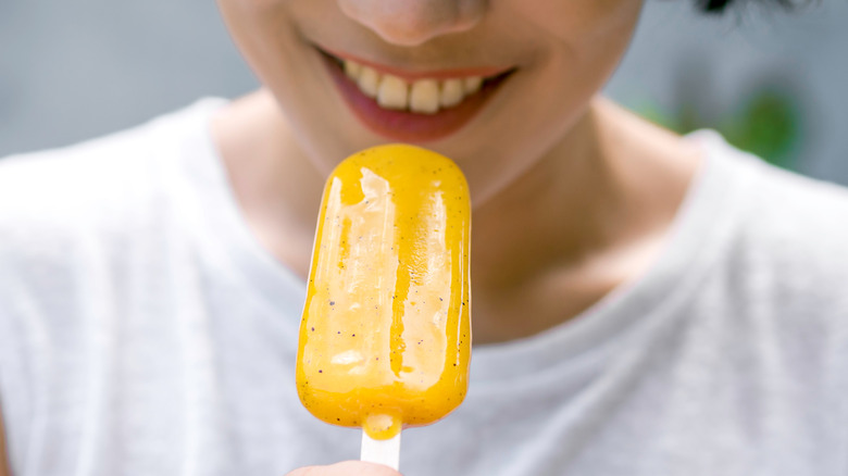 Woman eating popsicle
