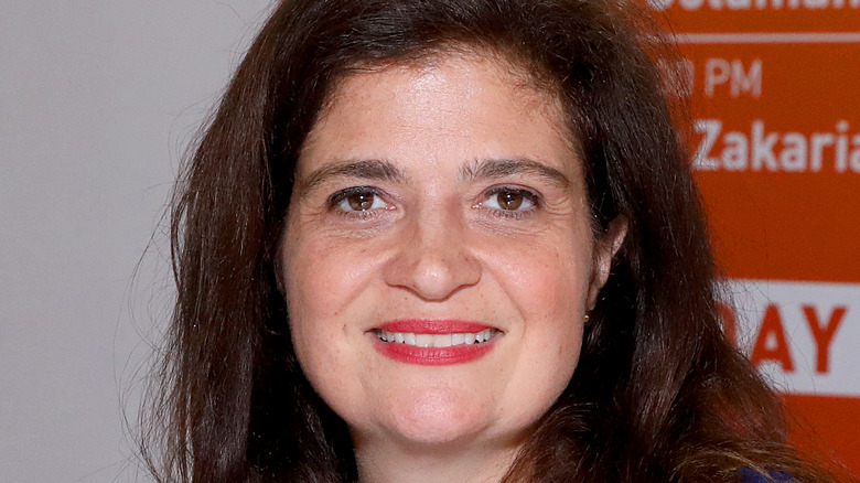 Iron Chef Alex Guarnaschelli smiles with red lipstick