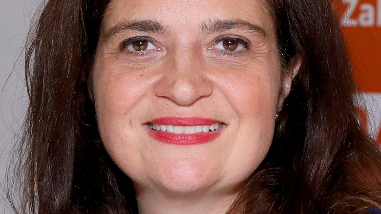 Alex Guarnaschelli with red lipstick and wide smile