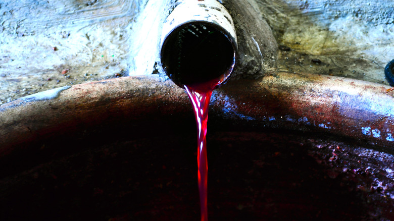 An ancient vessel pouring wine.