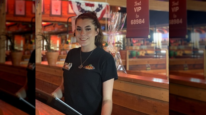 A Texas Roadhouse host smiling