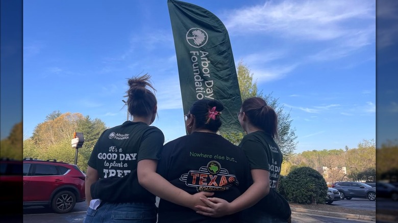 Texas Roadhouse employees embracing each other during a community event