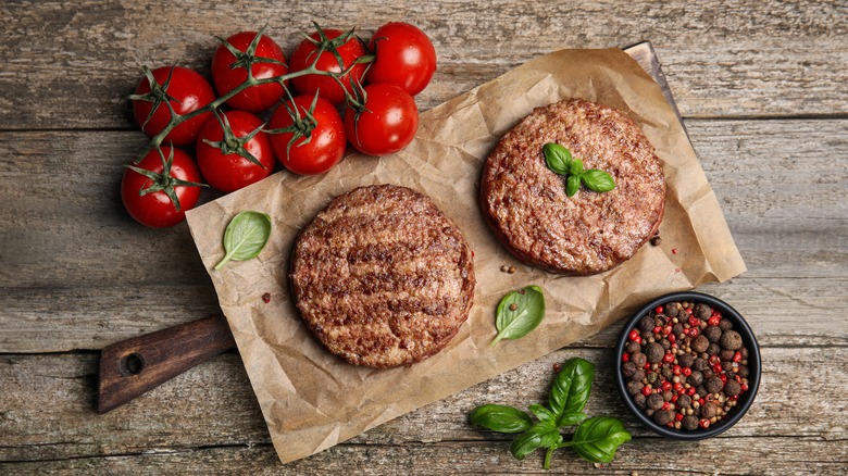 hamburger patties on cutting board