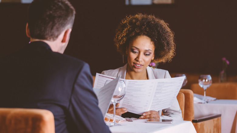 couple reading restaurant menu