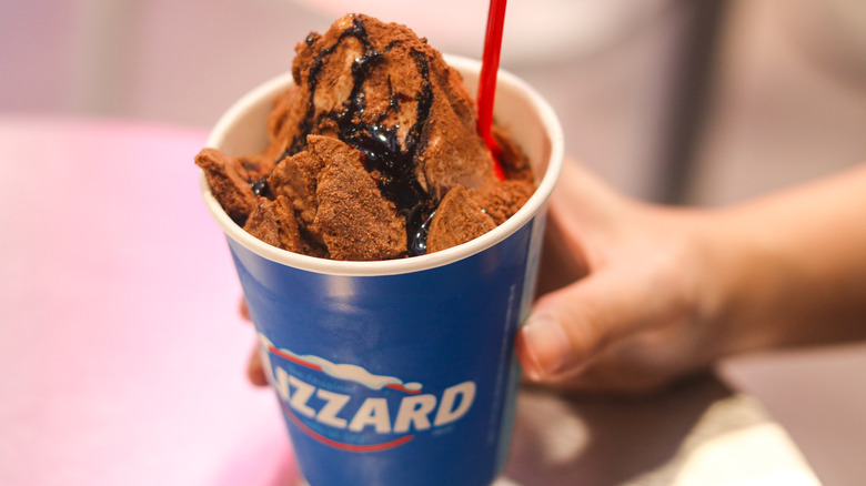Hand holding a chocolate DQ Blizzard