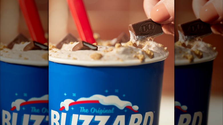 Dairy Queen Blizzard with hand holding chocolate pieces