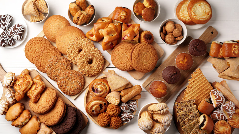 Wide array of baked goods displayed on different boards and vessels