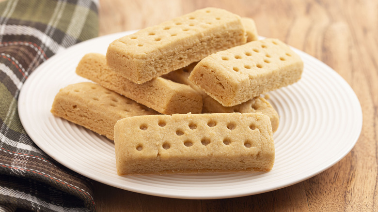 Plate of shortbread cookies with green and brown towel next to it
