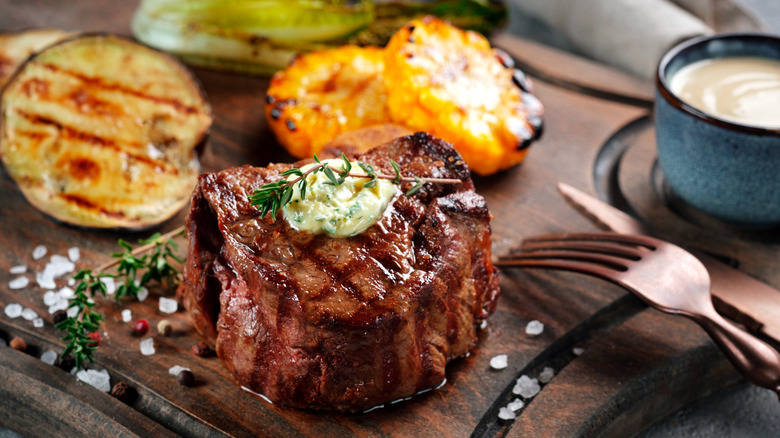 Grilled steak on wooden board