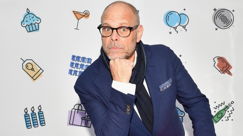 Alton Brown posing at a red carpet event