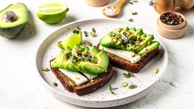 avocado toasts on a white plate