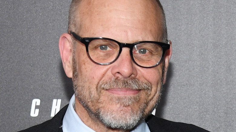 Alton Brown in suit and glasses