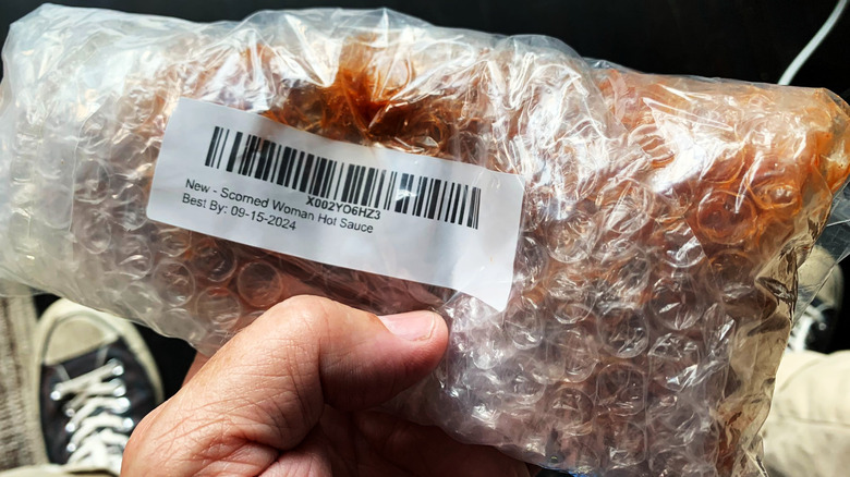 Broken hot sauce bottle in bubble wrap