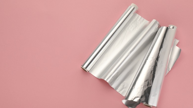 Rolls of foil on a pink backdrop
