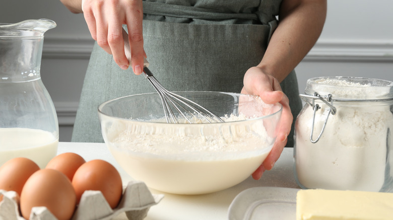 Baker mixing ingredients in bowl