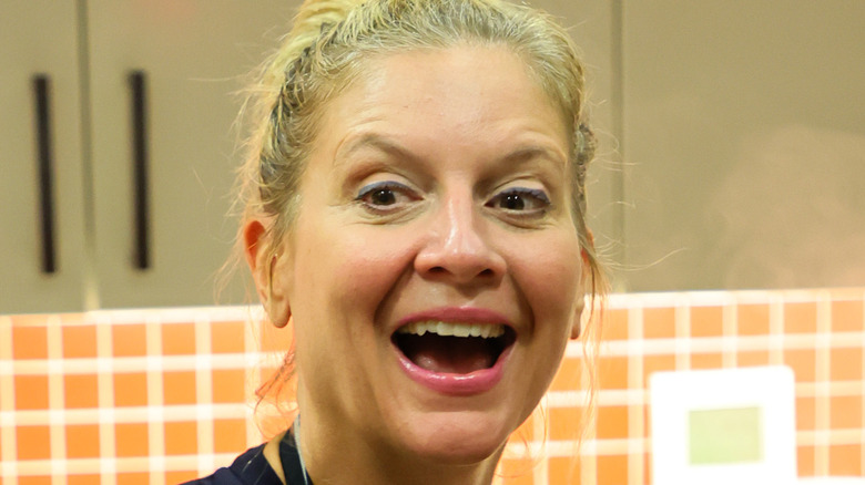 Amanda Freitag laughing while cooking