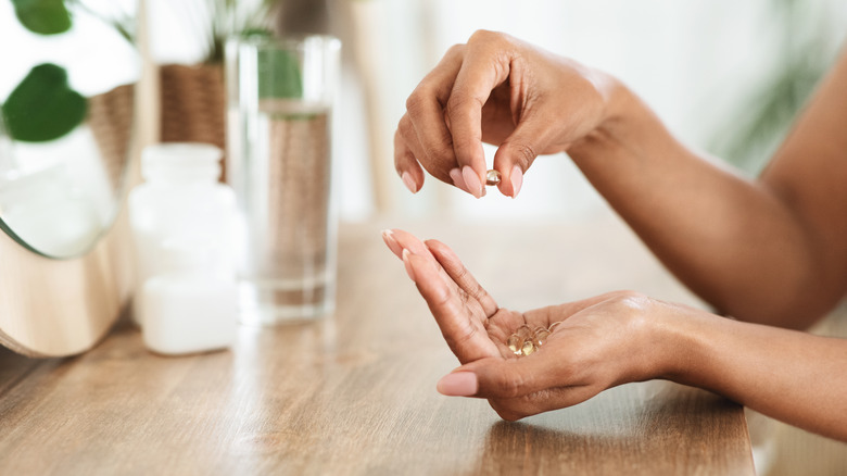 hands holding supplements