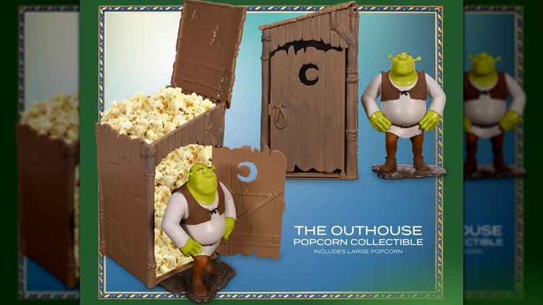 Novelty Shrek outhouse popcorn bucket with Shrek figurine.