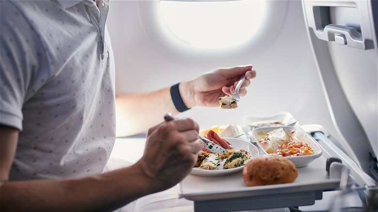 man eats mean on airplane