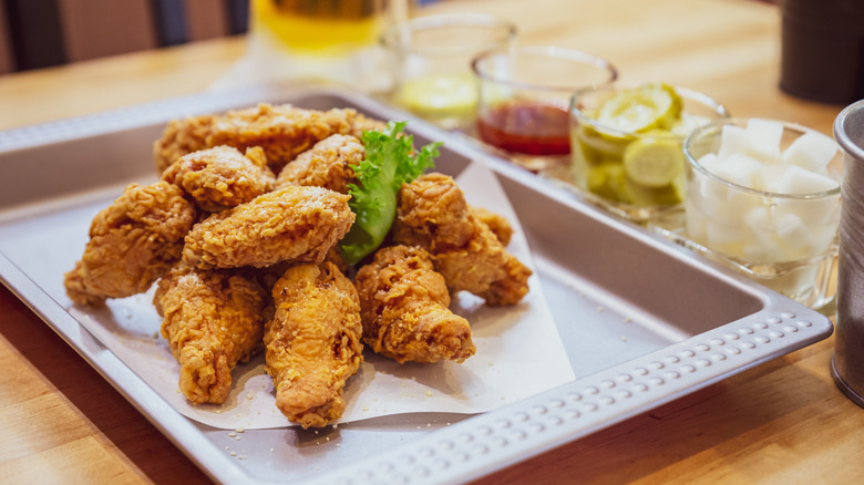 Golden Crunchy Korean Fried Chicken (basic Huraideu-Chikin) served with pickles and Soju.