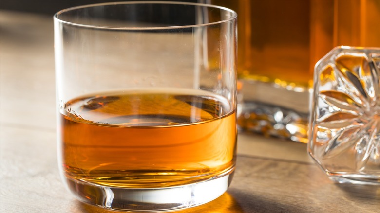 Canadian whisky served neat on a wood table.