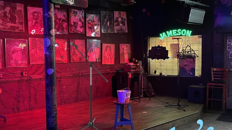 inside Northside Tavern, with a stage and a sign that reads "Jameson"