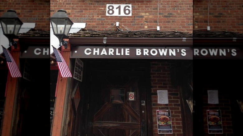 Charlie Brown's sign with an American flag to the left