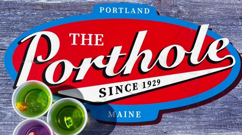 A sign on a table that reads: The porthole, since 1929, Portland, Maine