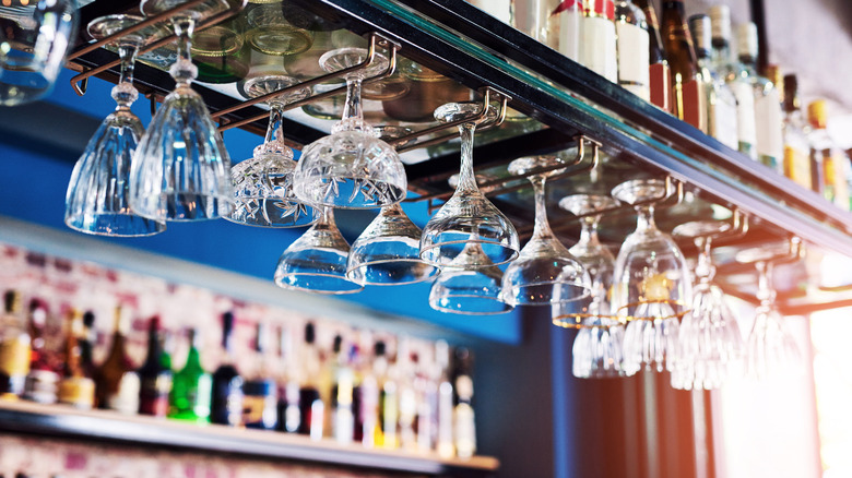 Glasses hanging upside down at a bar