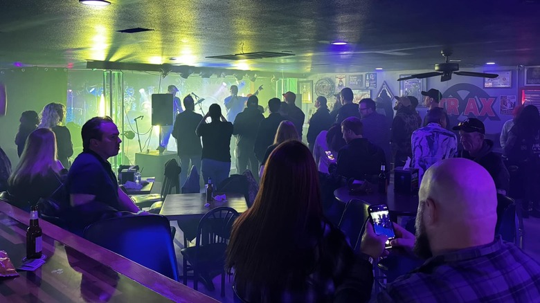 people inside a bar enjoying live music