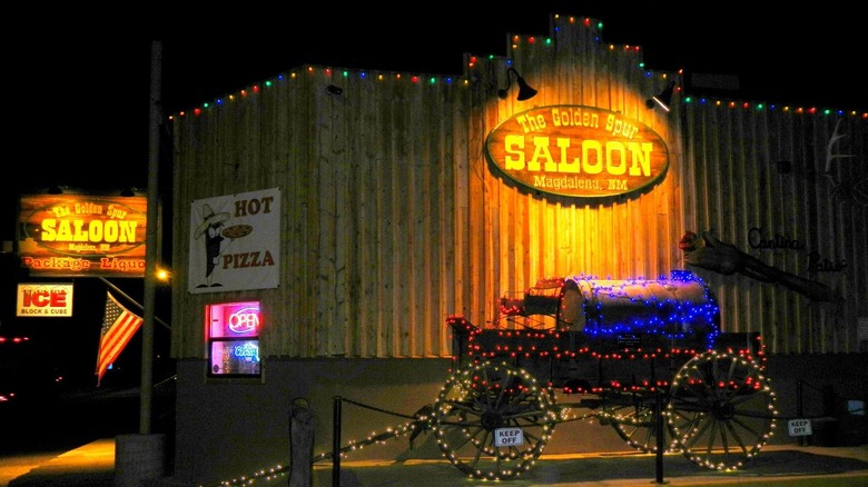 outside of the golden spur saloon, decorated with christmas lights