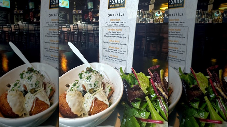 food on a table in front of a cocktail menu
