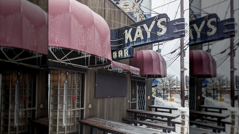 the outside of Kay's bar in winter, with ice on the sign and walls