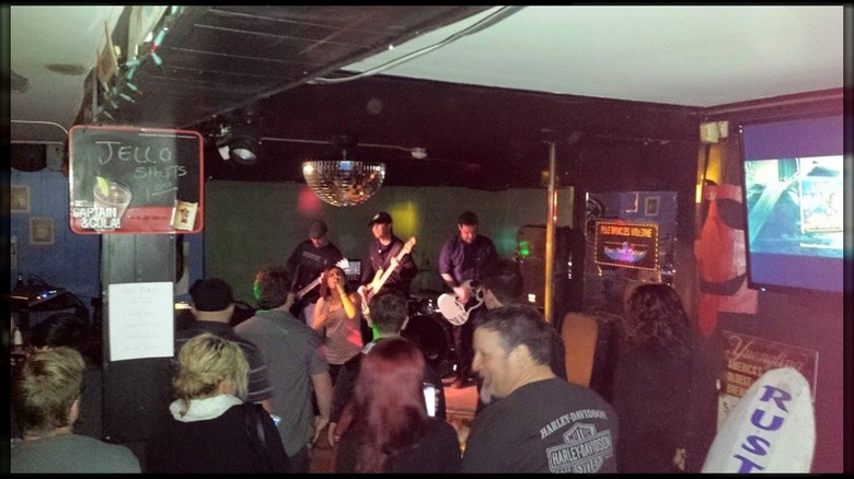 people enjoying a band playing live at a bar