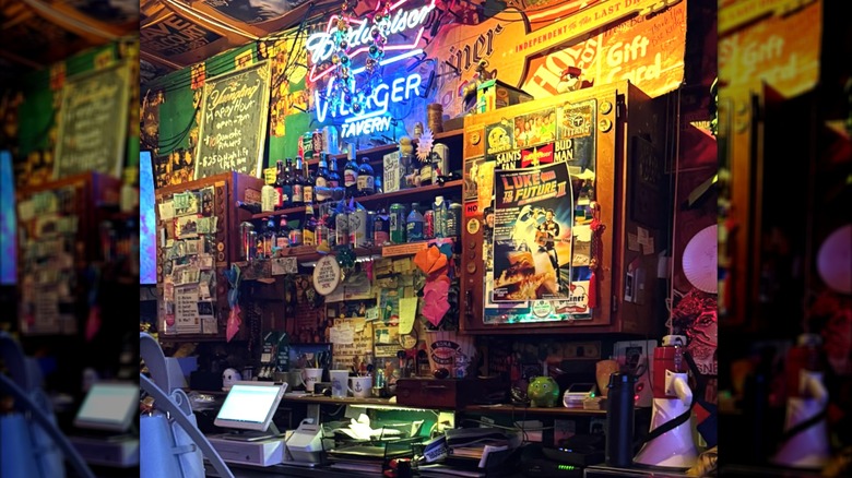 inside of a bar with a neon sign