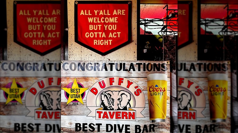a sign that reads "all yall are welcome but you gotta act right / congratulations duffy's tavern, best dive bar"
