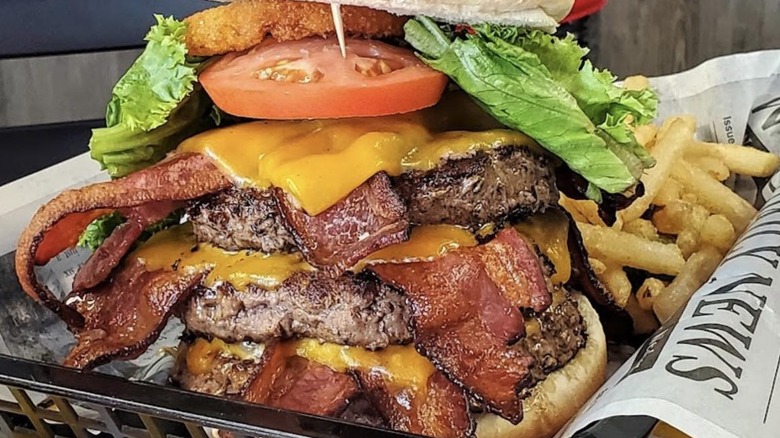 A triple OMG bacon cheeseburger with fries from Jimmy's Down the Street