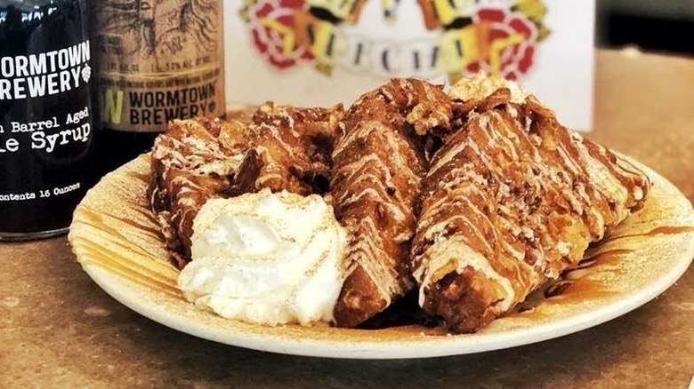 A plate of crunchy French toast with whipped cream on the table at Miss Worcester Diner