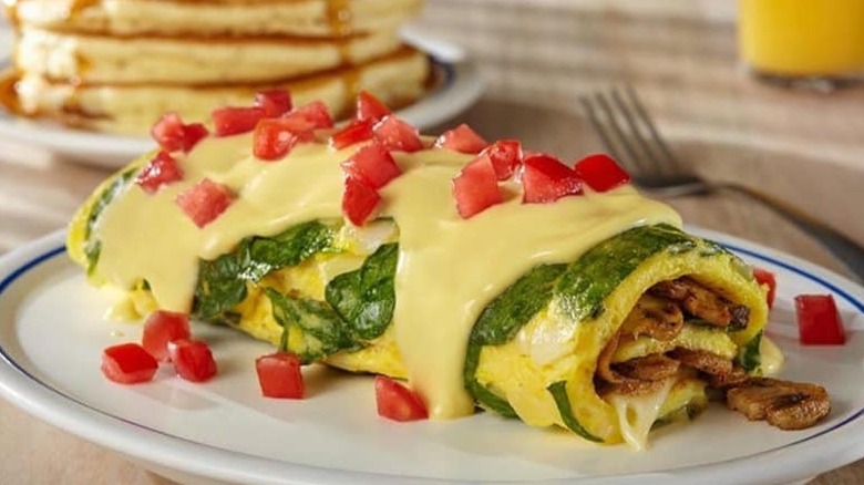 a mushroom omelette with tomato and cheese