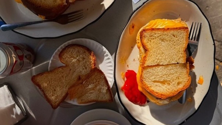 An overhead shot of a breakfast sandwich and side of toast with moody shadows at B&H Dairy