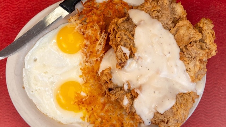 A plate of crispy chicken, eggs and hash browns at The Diner