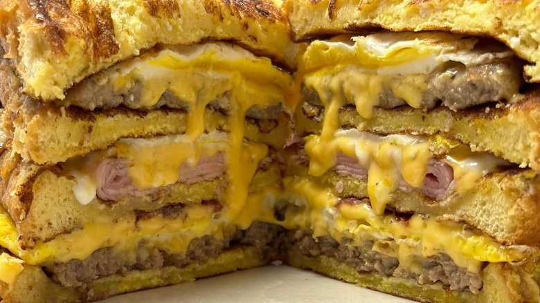 A close-up of a triple decker cheese breakfast sandwich