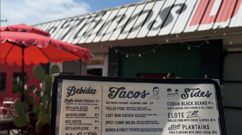 Exterior of Mas Tacos Por Favor with menu