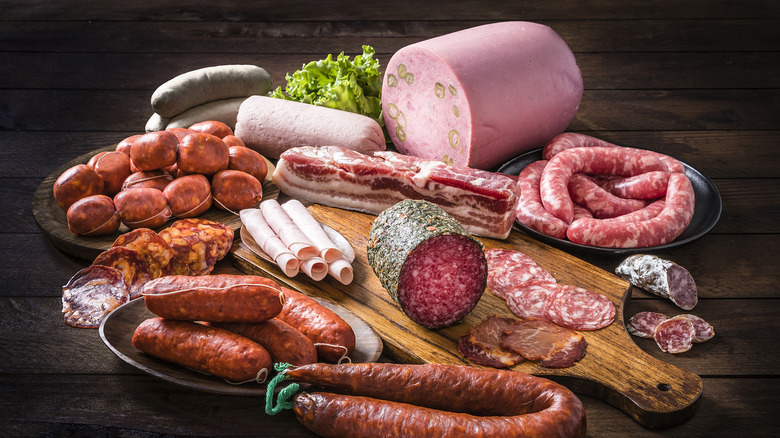 assorted pork products and wooden cutting board