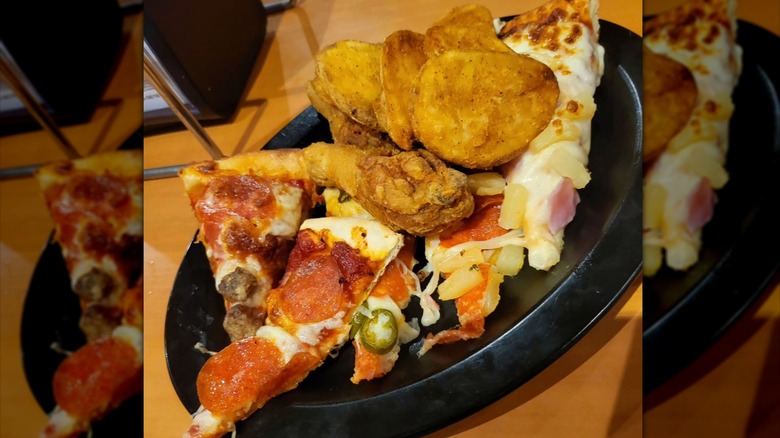 Plate of pizza, chicken, and potatoes at Shakey's
