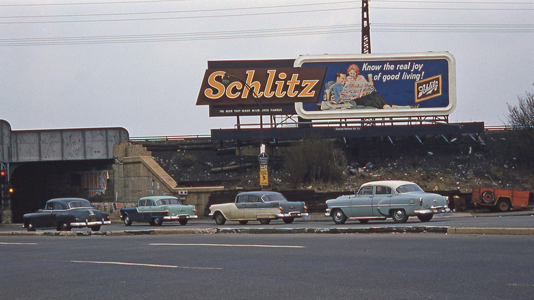 A Schlitz beer billboard on the side of the road from the 1950s