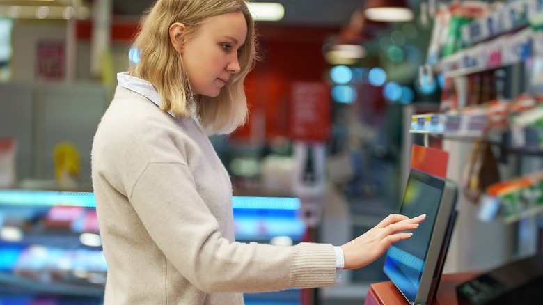 Woman using self-checkout 