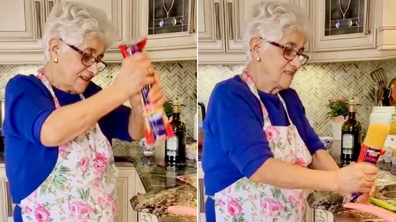woman banging spaghetti on counter