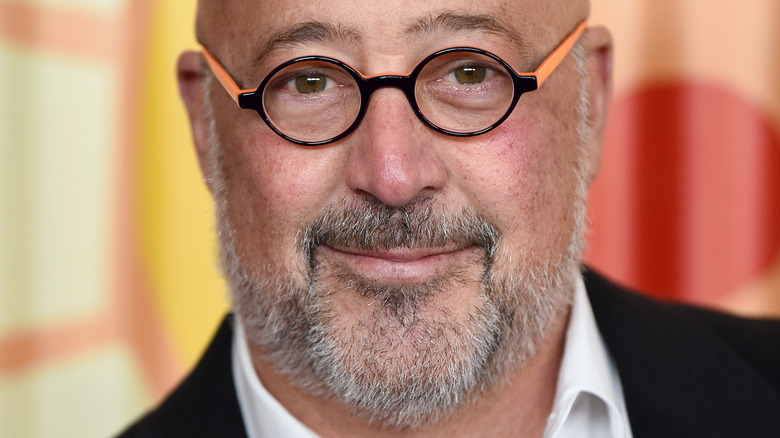 Andrew Zimmern smiles to camera
