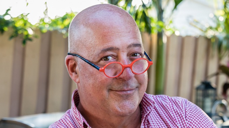 Andrew Zimmern in red glasses